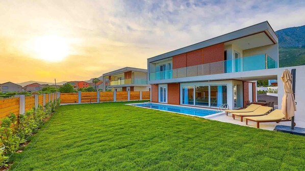 Relax in an outdoor space with a swimming pool and well-maintained lawn.