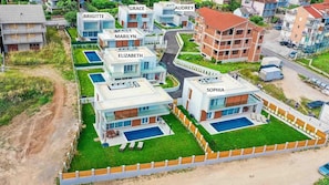 Stylish homes with clean lines and large windows offer a retreat with access to a swimming pool and well-maintained lawns.