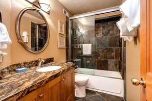 A bathroom with a marble countertop, a sink, a toilet, and a glass-enclosed shower. - Walk to Ski Slopes + Trails! Spacious 4-Bedroom Private Home with Fantastic Views, Hot Tub, A/C, and Wood Fireplace | PLA-1155 by KBM Resorts (Park City)