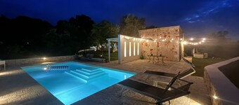 White stone typical apulian villa  with barrel roof  surrounded by olive trees.