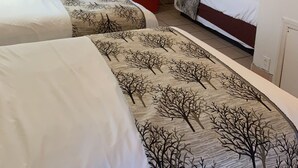 A hotel room with two beds, a TV, a red microwave, and a window with curtains. - SunShine Motel (Wildwood)