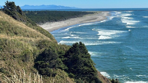 A coastal landscape with a beach, ocean waves, and distant mountains. - Beach Melody, Long Beach WA (Long Beach)