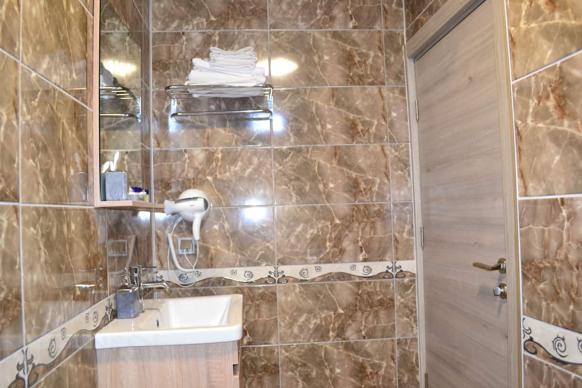 junior double room, courtyard view | bathroom | shower, free toiletries, hair dryer, slippers