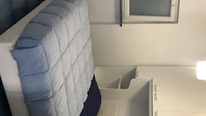 A room with a bed, a window, and a white cabinet. - APARTMENT IN VILLA (SANGINETO)