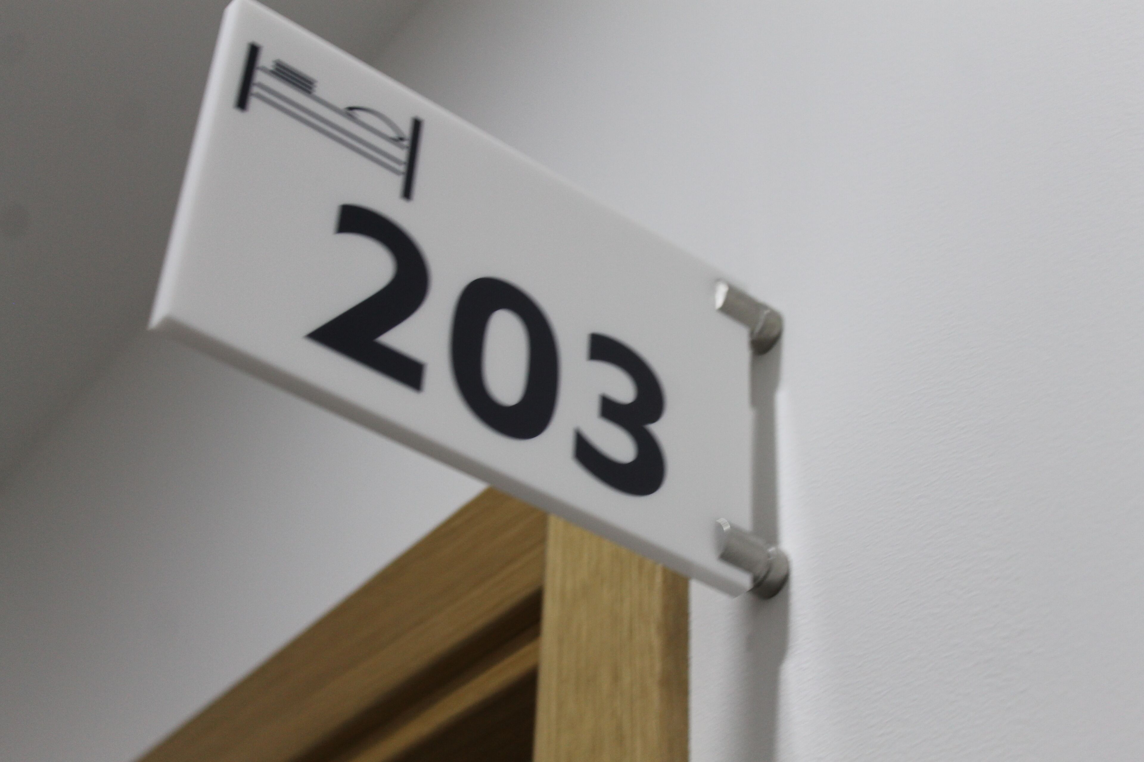 A white sign with the number 203.
