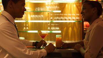 A bar setting with a bartender and a customer.