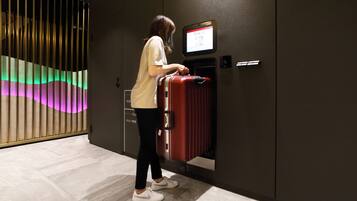 A person using a self-service kiosk in a hotel lobby.
