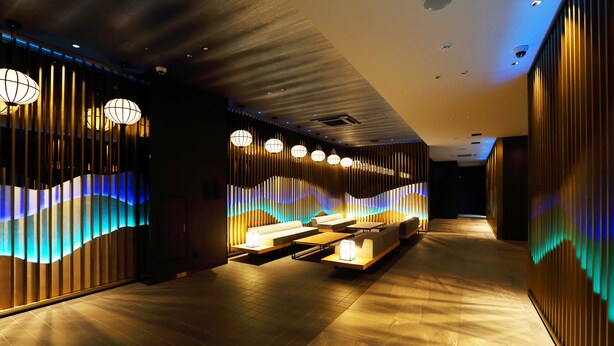 A modern hotel lobby with a seating area, wooden paneling, and ambient lighting. - Henn na Hotel Premier Nara (Nara)