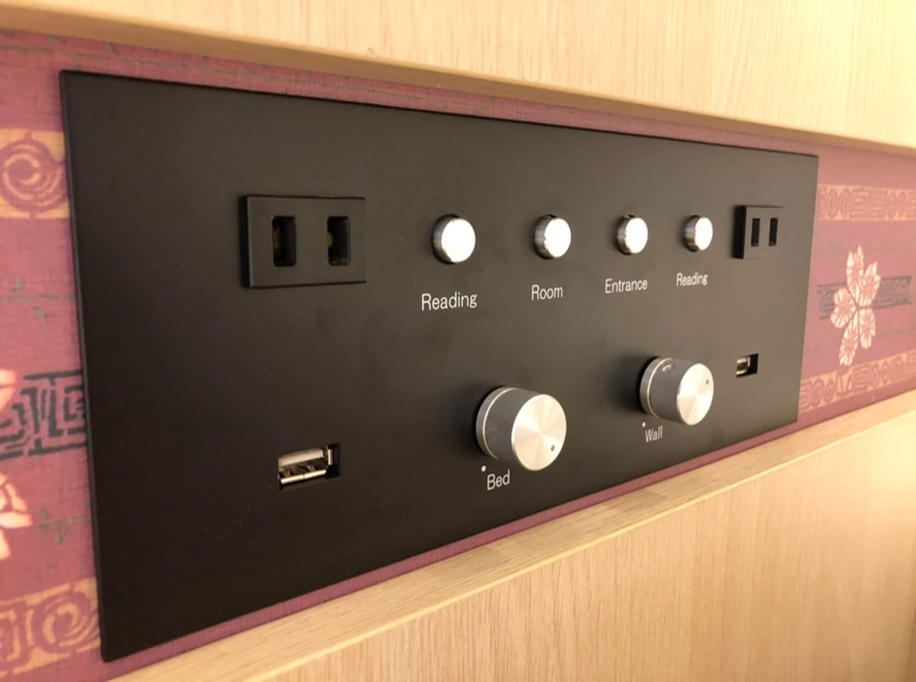 A control panel with labeled switches for Reading, Room, Entrance, Reading, and Wall.