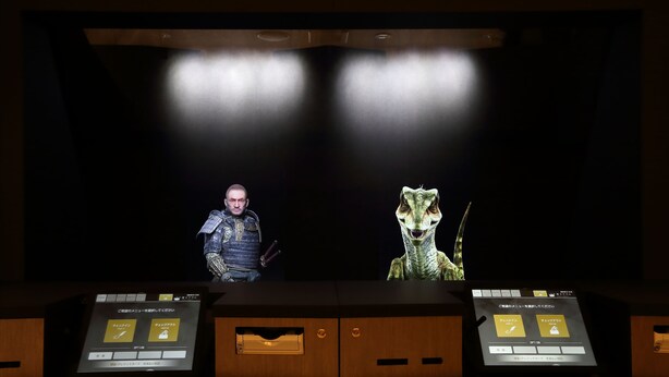A reception desk with a digital screen displaying information. - Henn na Hotel Premier Nara (Nara)