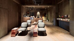 Ein modernes Interieur mit einer Rezeption, einer Sitzecke und Bücherregalen.