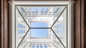 A skylight with a geometric design, allowing natural light into a room. - Be Mate Málaga Centro (Málaga)