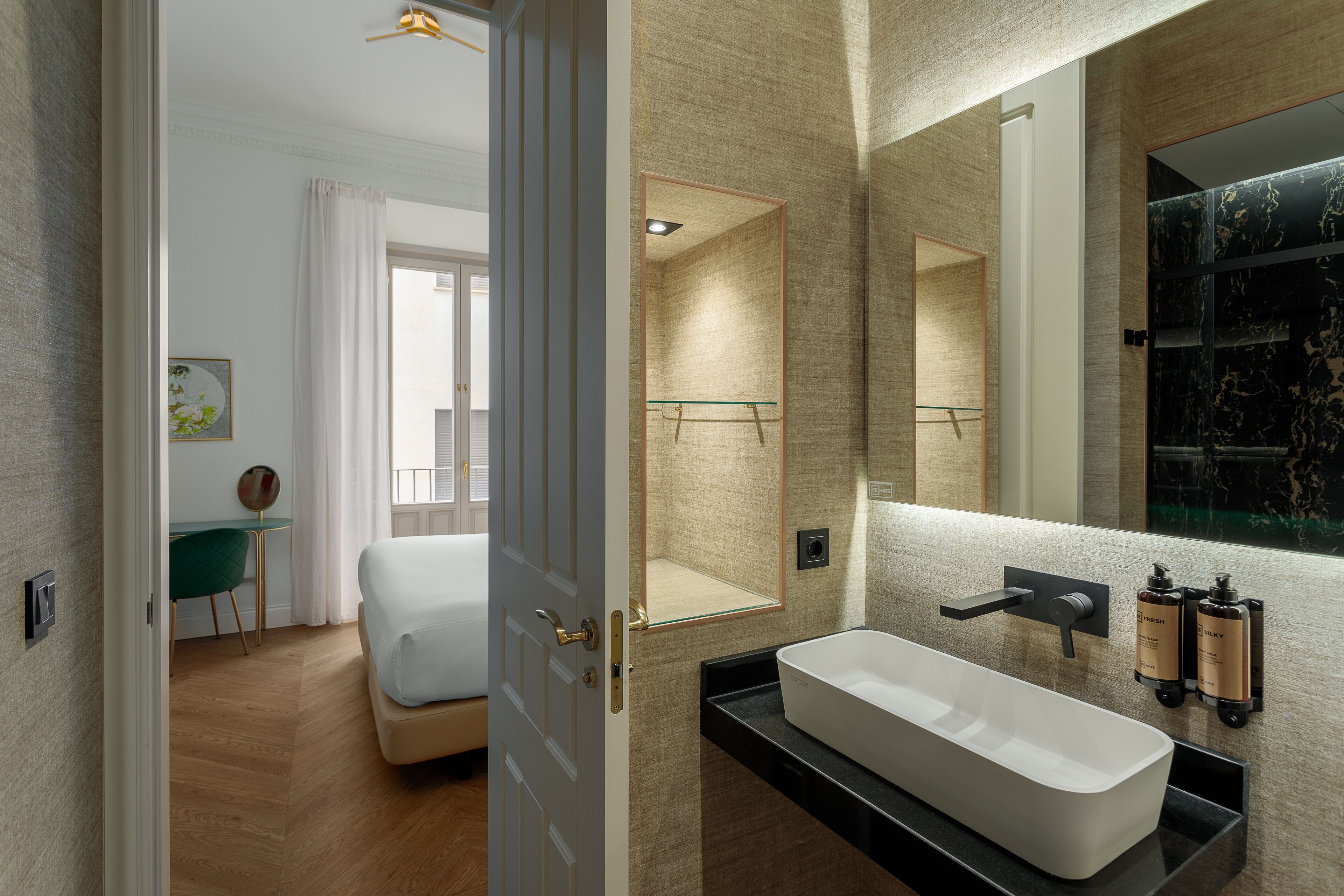 A modern bathroom with a large mirror, a freestanding bathtub, and a sleek vanity.