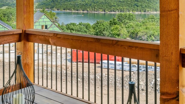 A wooden deck with a view of a lake and hills. - Indoor/Outdoor Pool, Pickleball, Private Hot tub (Hollister)