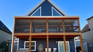A two-story house with a balcony, a sliding glass door, and a small porch area. - Indoor/Outdoor Pool, Pickleball, Private Hot tub (Hollister)