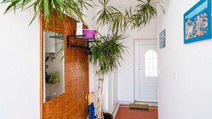 A hallway with a wooden wall, a mirror, and several potted plants. - apt Dubrovnik,sea view,near Old tow (Dubrovnik)