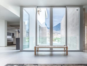 Enjoy a room with a large sliding glass door leading to a balcony with a view of the surrounding landscape.