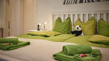 Cozy retreat with a plush bed, bedside lamp, and soft towels.
