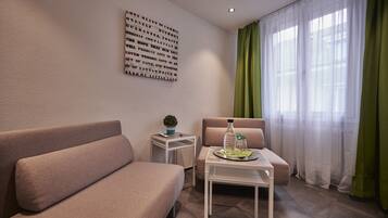 Deluxe Suite, 2 Bedrooms | Living area | 30-cm flat-screen TV with satellite channels, TV, first-run movies