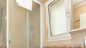 A bathroom with a toilet, a sink, and a glass shower enclosure. - #SEA SHELL bubble jacuzzi (Dubrovnik)