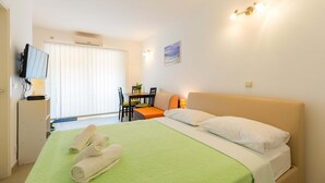 A hotel room with a bed, a desk, a chair, and a television. - Perfect Studio on Lapad Peninsula 1 (Dubrovnik)