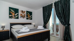 Un dormitorio con cama, mesitas de noche y cuadros en la pared.