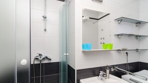 A modern bathroom with a glass shower enclosure, a white sink, and chrome fixtures. - Corso turquoise view, 1BR APT with balcony and sea view (Mljet)