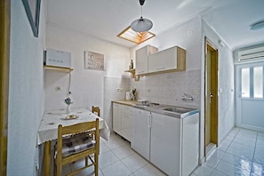 Enjoy cooking in this well-equipped kitchen with a central island, sink, and stove, perfect for meal preparation and dining.