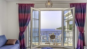 A room with a view of the sea, a balcony with chairs, and a sofa. - Jasmin Lush TOP FLOOR - one bedroom apartment (Mljet)