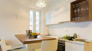 A modern kitchen with a wooden countertop, white chairs, a sink, and a glass cabinet with wine glasses. - Superior suite with sea view :) PRECIOUS MOMENTS (Mljet)
