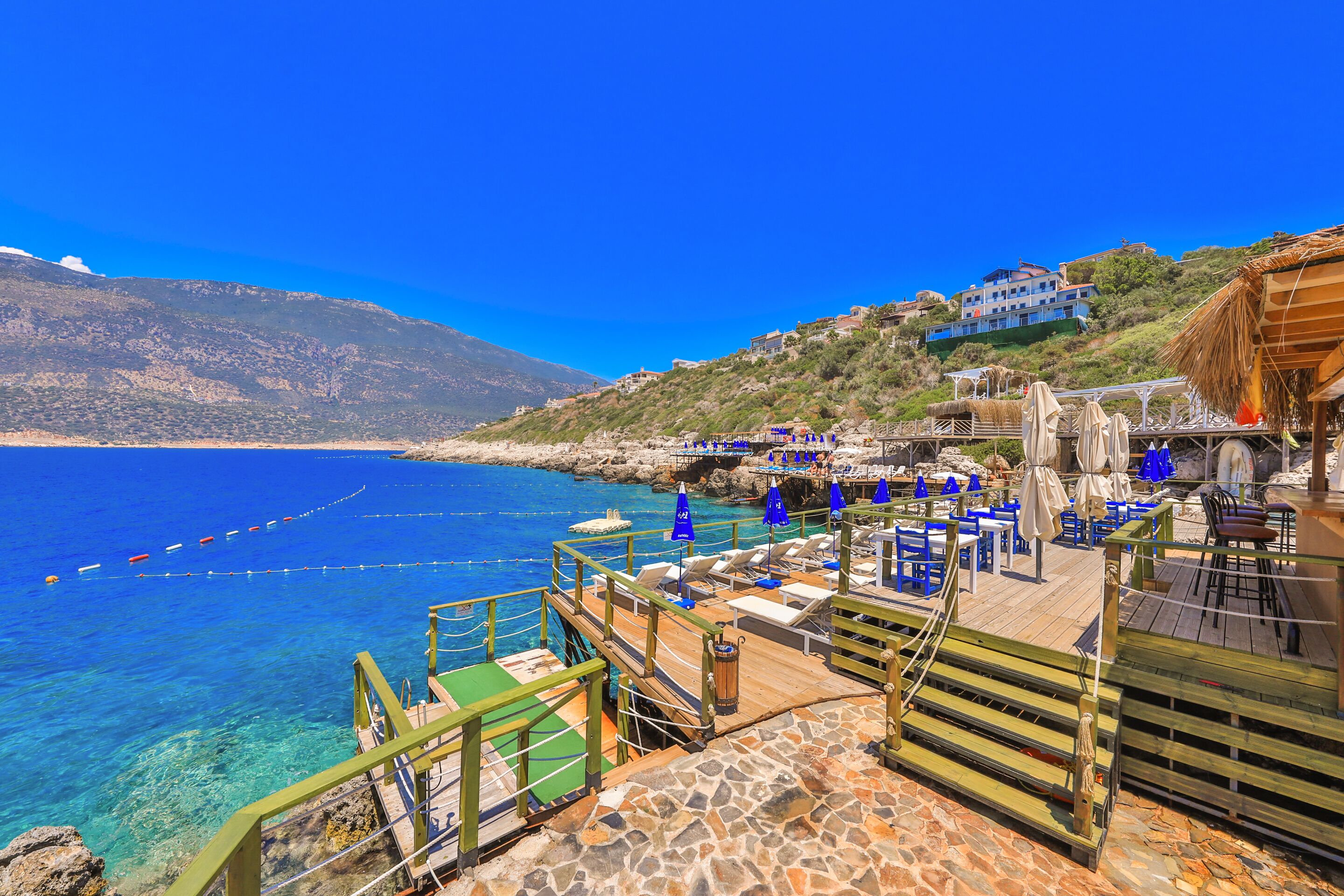 private beach, black sand, sun-loungers, beach umbrellas