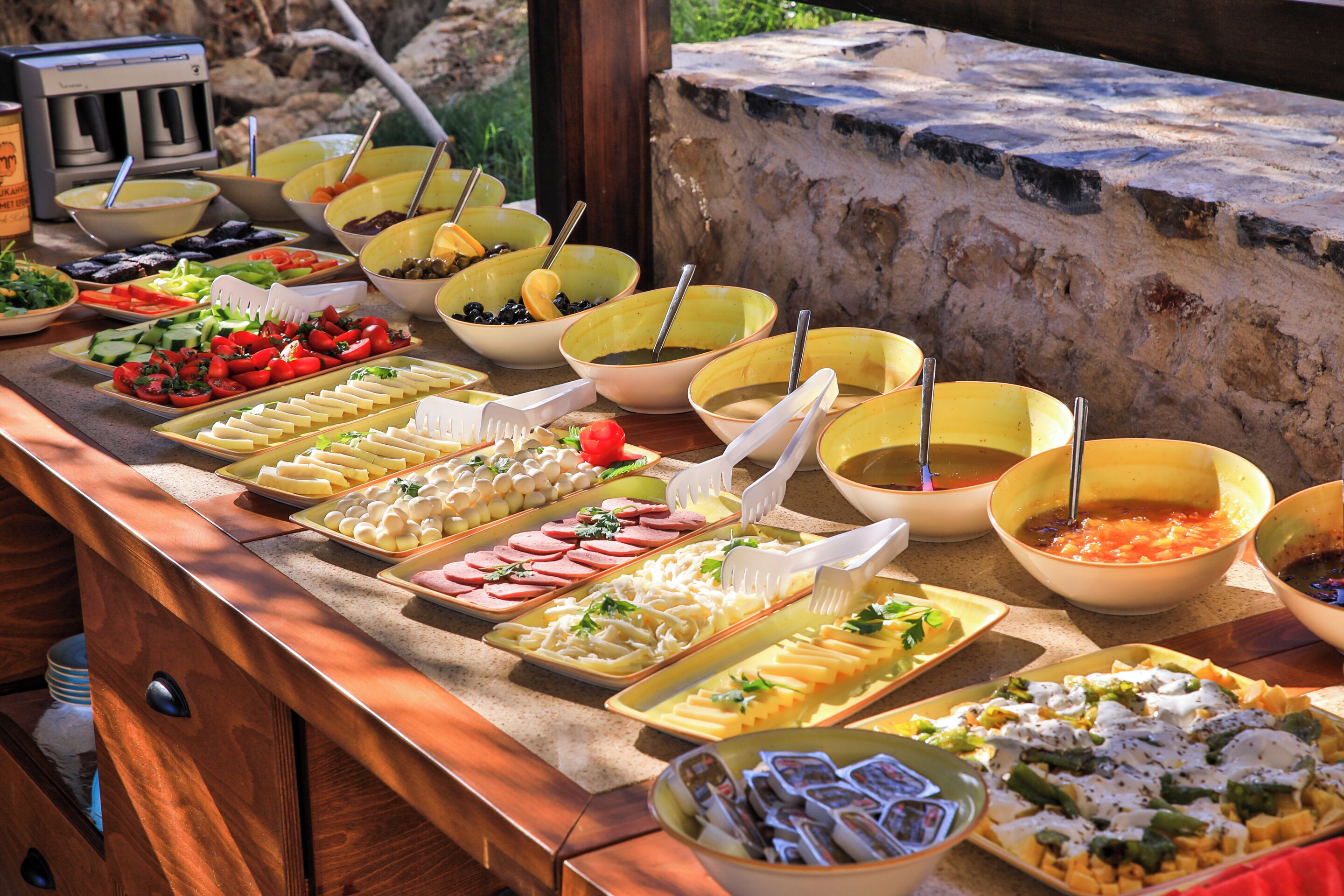 A buffet with various food items and utensils.