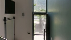 A modern interior with a staircase leading to a balcony.