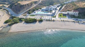 An aerial view of a coastal resort with a beach, a pool area, and several buildings. - Tesoro Blu Hotel & Spa - Adults Only (Kefalonia)