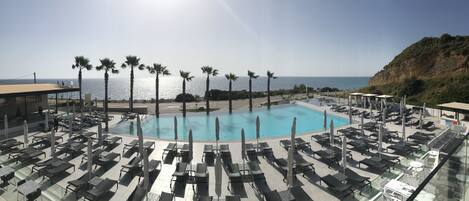 Seasonal outdoor pool, open 10:30 AM to 6:30 PM, pool umbrellas