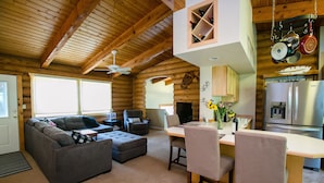 A cozy log cabin interior with a living room, dining area, and kitchen. - Nederland Getaway 4 Bedroom Home by RedAwning (Nederland)