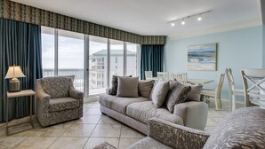 A modern living room with a sofa, armchairs, and a dining area. - St. Croix 1406 3 Bedroom Condo by RedAwning (Destin)