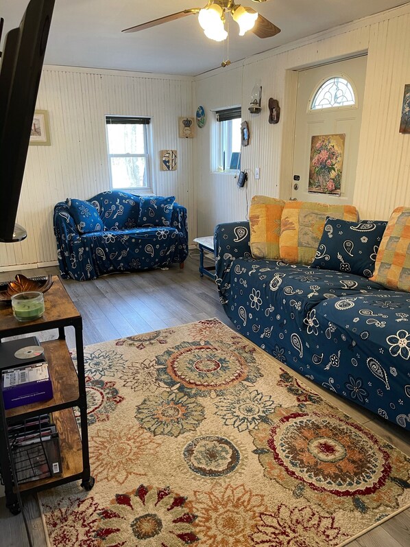 A cozy living room with two sofas, a coffee table, and a rug.