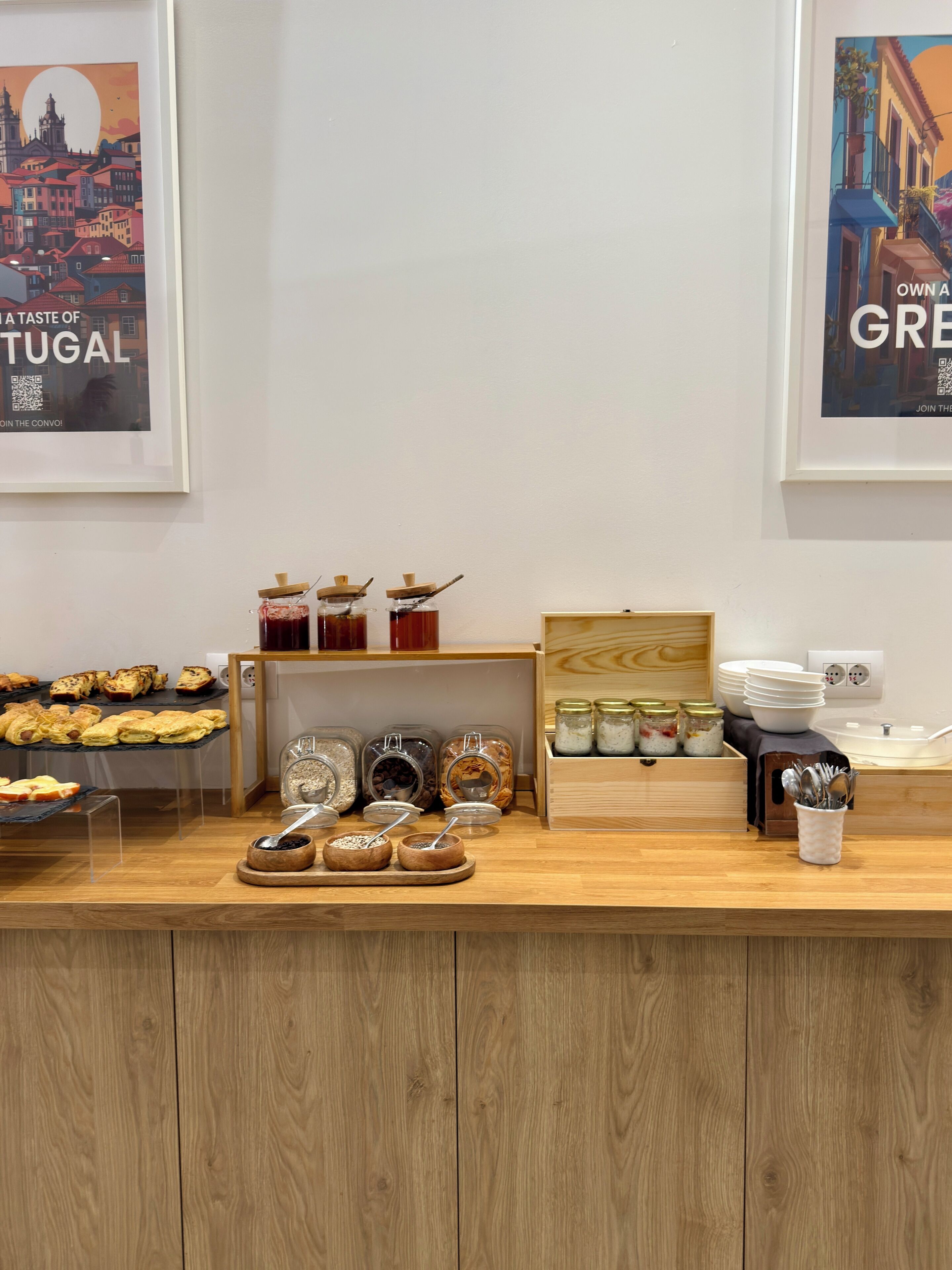 Un bufé de desayuno con bollería, mermeladas y salsas.