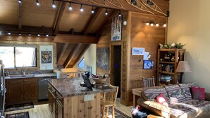A rustic cabin interior with a kitchen, dining area, and a cozy living space. - Northstar Mountain charm & luxury, near shuttle, 10 minutes to slopes, sleeps 6, (Truckee)