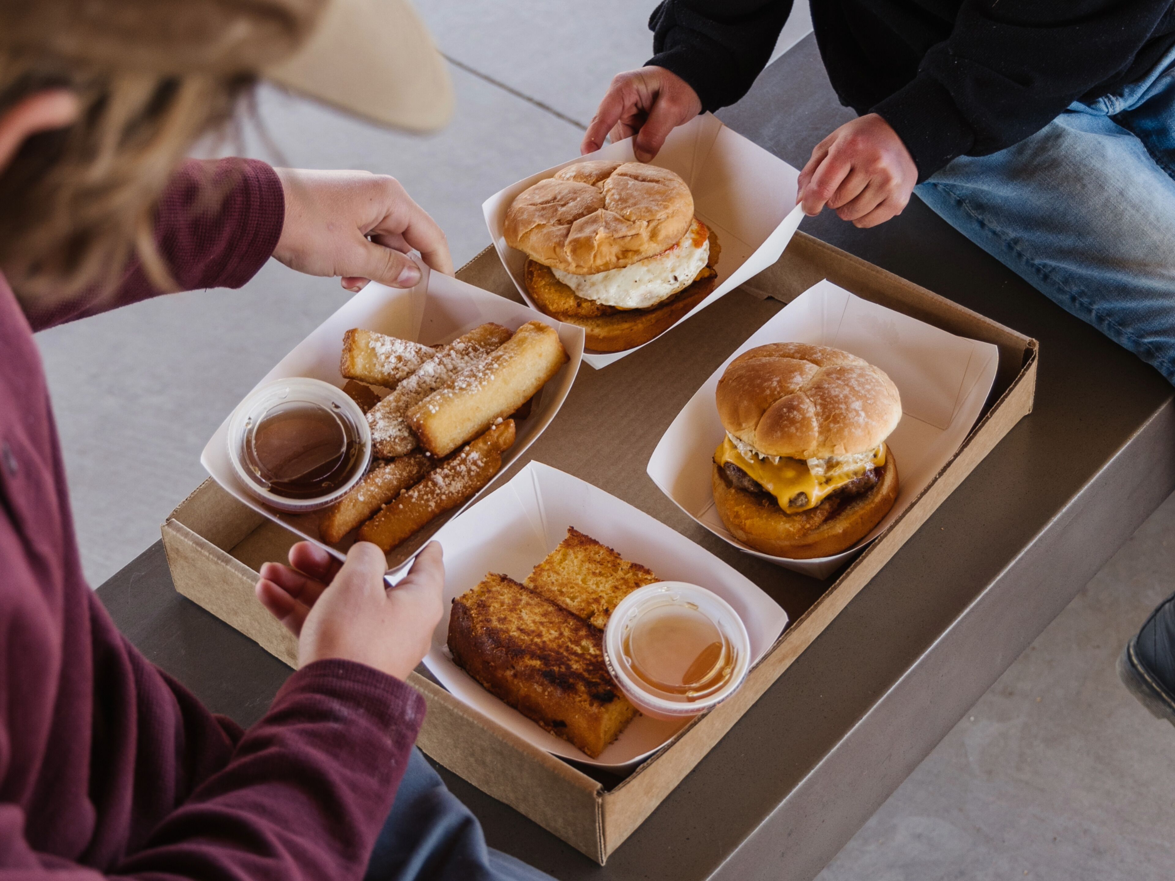 A table with food items including a burger, fries, and a dessert.