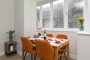 Enjoy meals in this dining area with a table for four, surrounded by a window with a view.