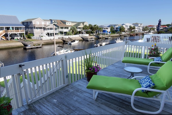 Open section of second floor porch for sunning in a lounge chair.
