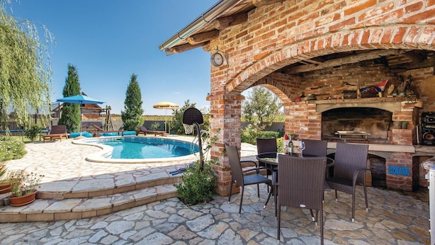 A backyard with a swimming pool, outdoor seating, and a brick fireplace. - Stunning Home in Ozalj With 5 Bedrooms, Wifi and Outdoor Swimming Pool (Karlovac)