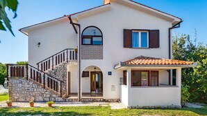 A two-story house with a stone staircase, a small porch, and a tiled roof. - Beautiful Home in Kapelica With Wifi and 2 Bedrooms (Labin)