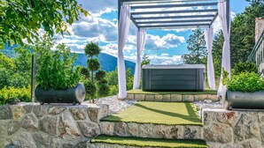A stone staircase leading to a pergola with a hot tub, surrounded by greenery and a mountainous backdrop. - Awesome Home in Poljica Imotska With Wifi and 5 Bedrooms (Podbablje)