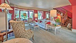 A living room with a sofa, armchairs, a coffee table, and a staircase. - Wine Country Home with Yard; Walk to Downtown! (Walla Walla)