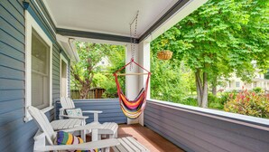 A covered porch with white Adirondack chairs and a hammock. - Wine Country Home with Yard; Walk to Downtown! (Walla Walla)