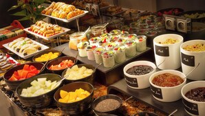 A buffet with various food items including fruits, pastries, and desserts. - Hotel Essence  (Prague)