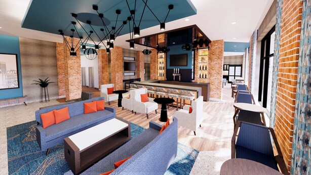 A modern hotel lobby with a bar area, seating arrangements, and a kitchen visible through the brick walls.